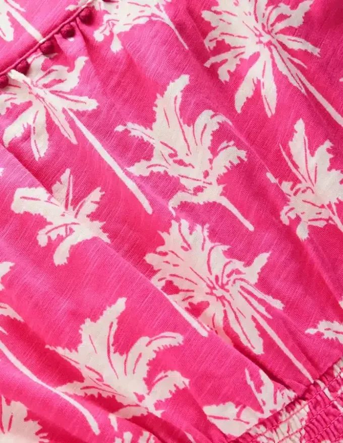 Ciara Pom Trim Jersey Romper Pink Palm Trees