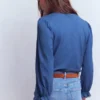 Emily Pom Trim Ruffle Shirt Denim Blue Emily Pom Trim Ruffle Shirt Denim Blue